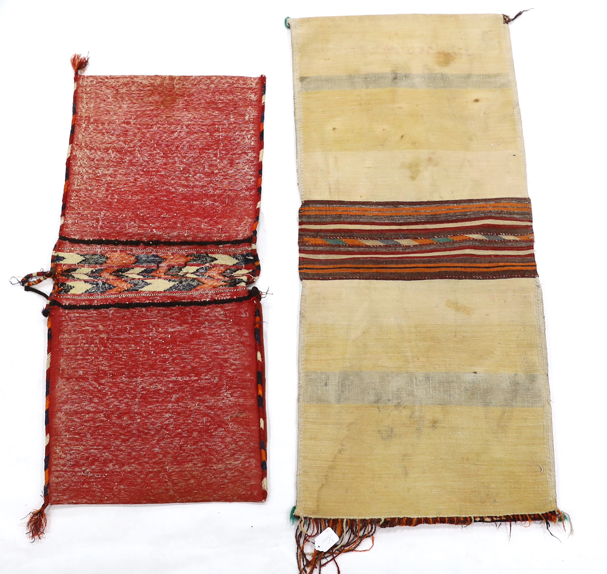 Two late 19th / early 20th century Caucasian saddle bags, largest 132cm long x 59cm wide